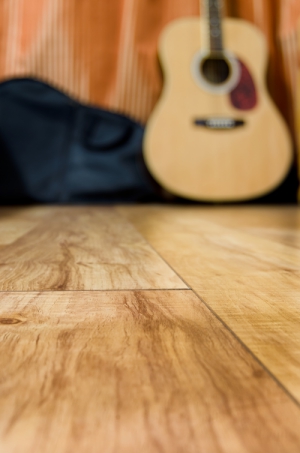 acoustic quitar in a room with wooden floor